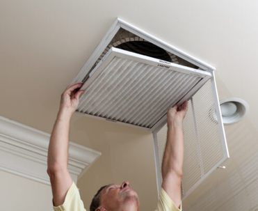 Man working on home filter system