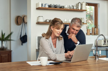 Couple looking at the screen of a laptop