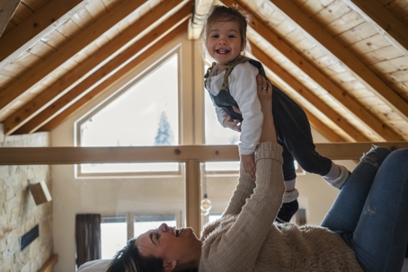 A mom playing with her baby in the attic