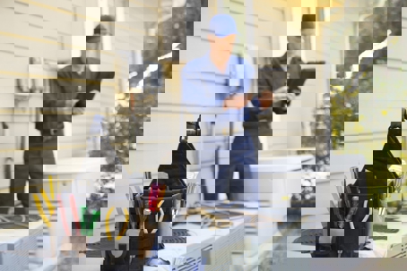 HVAC Technician looking at an iPad