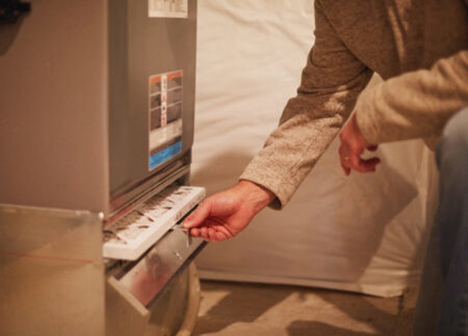 Technician checking a furnace filter
