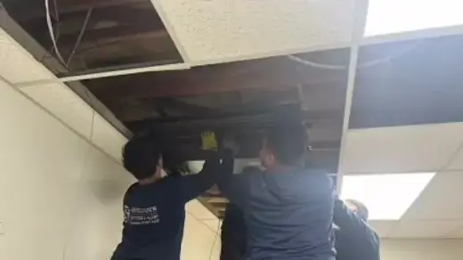 Men installing AC in the roof